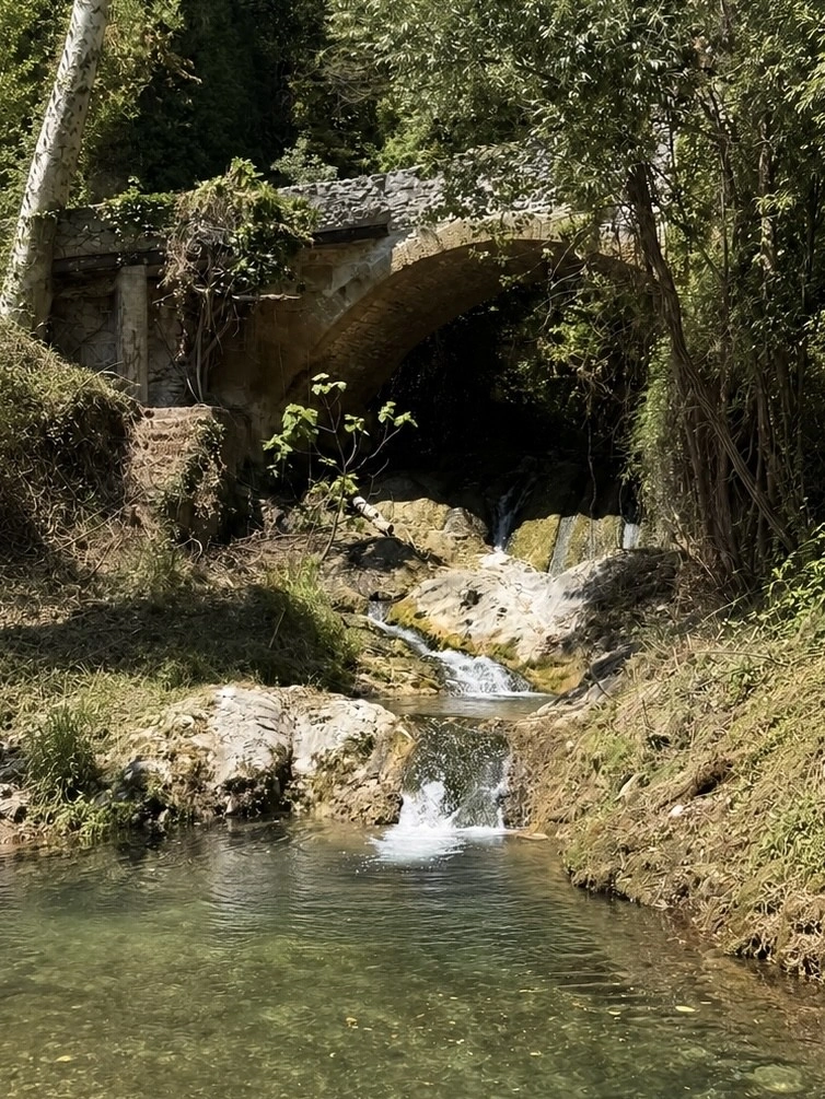 Cascade de l'Aigues Brun sous le pont de pierre, dans le parc de l'hôtel O Mamma Mia à Lourmarin